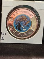 Reverse of 2024 coloured Inuit Nunangat toonie in holder