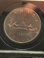 Reverse of 1980 Canadian Voyageur dollar in holder