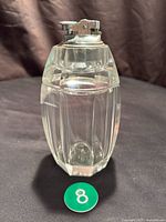 Full view of lighter showing glass body and metal top