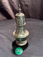 Full view of sugar shaker showing overall form and tarnish