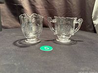 Cream and sugar set side by side on table