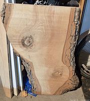 Front view of ash slab showing bark edges, knots and grain