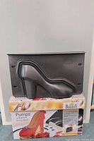 Front view of assembled two-part shoe mould on box