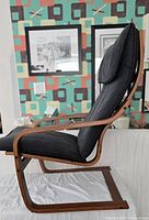 Side profile showing curved bentwood frame and black cushion
