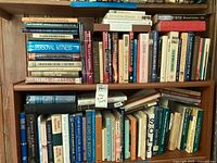 Bookshelves with about 40-60 Jewish-themed books including titles on philosophy, pastoral care, history, and law in hardcover and softcover.