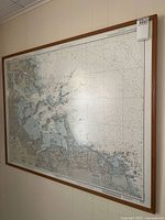 Framed nautical chart mounted on wall, large format, showing coastal details around Boston Harbor, Massachusetts.