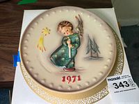 Front side of the plate showing the child holding a candle, comet, pine trees, and the year 1971 in raised detail.