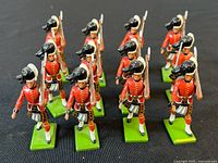 Full group of 12 Cameron Highlander toy soldiers on green bases