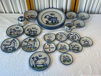 All 21 pieces arranged on table showing variety of sizes and motifs