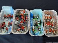 Four trays of metal toy soldiers shown overall