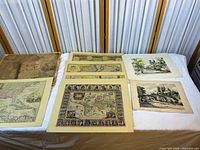 Overview of all five matted prints and portfolio cover on table