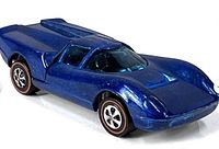 Left front and side view of metallic blue Lola GT70 showing overall body and redline wheels