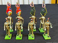 Front view of all six Fusiliers figurines standing on green bases