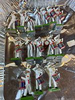 Top view of 12 painted soldier figurines in foil pan