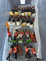Overall view of assorted British ceremonial miniature soldiers in storage bin