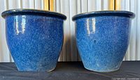 Front view of both blue glazed planters