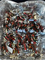 Large aluminium pan containing many painted Pakistan Army band figurines