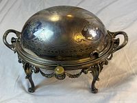 Full view of silver-plated chafing dish on stand