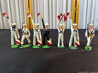 Front view of six painted metal Barclay Navy sailor figurines