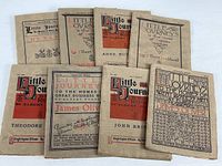 Nine paperback booklets titled 'Little Journeys' by Elbert Hubbard arranged together showing aged covers with red and black print.
