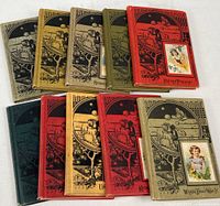 Overview photo of all 10 little story books with varied cloth covers in beige, green, red, black, and yellow, each with illustrated front cover and color child portrait