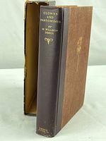 Photo showing the book with its protective sleeve. The spine reads 'Clowns and Pantomimes' by M. Wilson Disher, published by Houston Mifflin.
