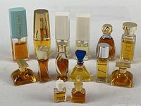 Group photo of all perfume and cologne bottles arranged in two rows showing full and partial bottles with varied caps and liquid levels