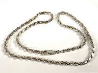 Full view of sterling silver rope chain necklace laid out flat showing length and chain style