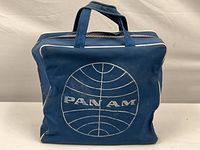 Front view showing large white Pan Am globe logo on blue background with white piping edges.