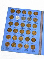Photo of first album page showing Lincoln Head pennies dated 1941 to 1950S with mint marks and mintage numbers.