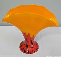 Full view of yellow and red glass fan vase