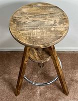 Top view of round wooden seat showing grain and finish