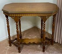 Full view of octagonal end table with turned legs and lower shelf
