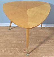 Top view of triangular maple side table with visible grain pattern