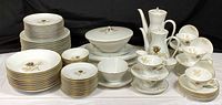 Full set showing stacked plates, bowls, cups, pots, serving pieces