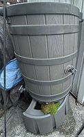 Full view of rain barrel on base showing spigot