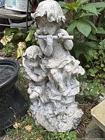 Full view of resin cherub statue showing both figures and base