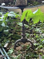 Full view of cast iron pedestal table in garden setting