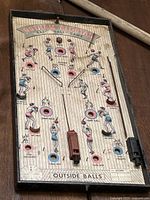 Full view of antique Gotham All-Star Baseball pinball game board showing graphics, plunger, and ball return
