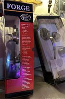 Front view of boxed cylindrical knob/deadbolt set beside clamshell handle/deadbolt set