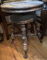 Full view of stool showing seat, legs and floor for scale