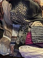 Overview of folded scarves showing multiple colours and patterns