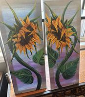 Front view of both sunflower paintings side by side