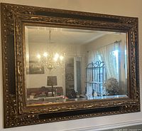 Front view showing entire mirror and ornate gold frame