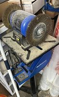 Overall view of Mastercraft bench grinder with dual wire wheels on pedestal stand