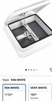 Stock image of white RV roof vent fan showing lid open and fan blade