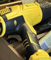 Close-up of SainSmart yellow/black heat gun showing grip, vents and branding