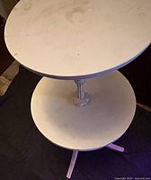 Angled view of top and lower shelves with central column