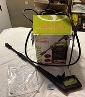 Pressure washer, hose, wand, manual and box displayed