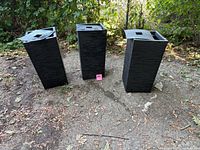 Three tall black square tapered planters front view